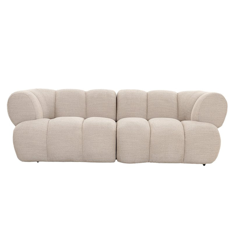 Curved beige sofa with plush, segmented cushions and rounded armrests.